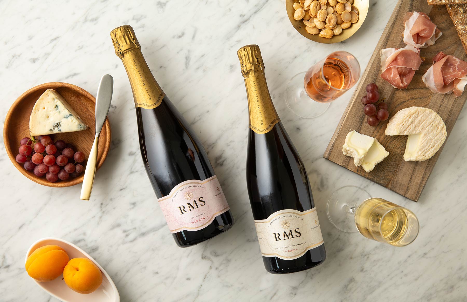 Two bottles of ROCO Sparkling wine with food.