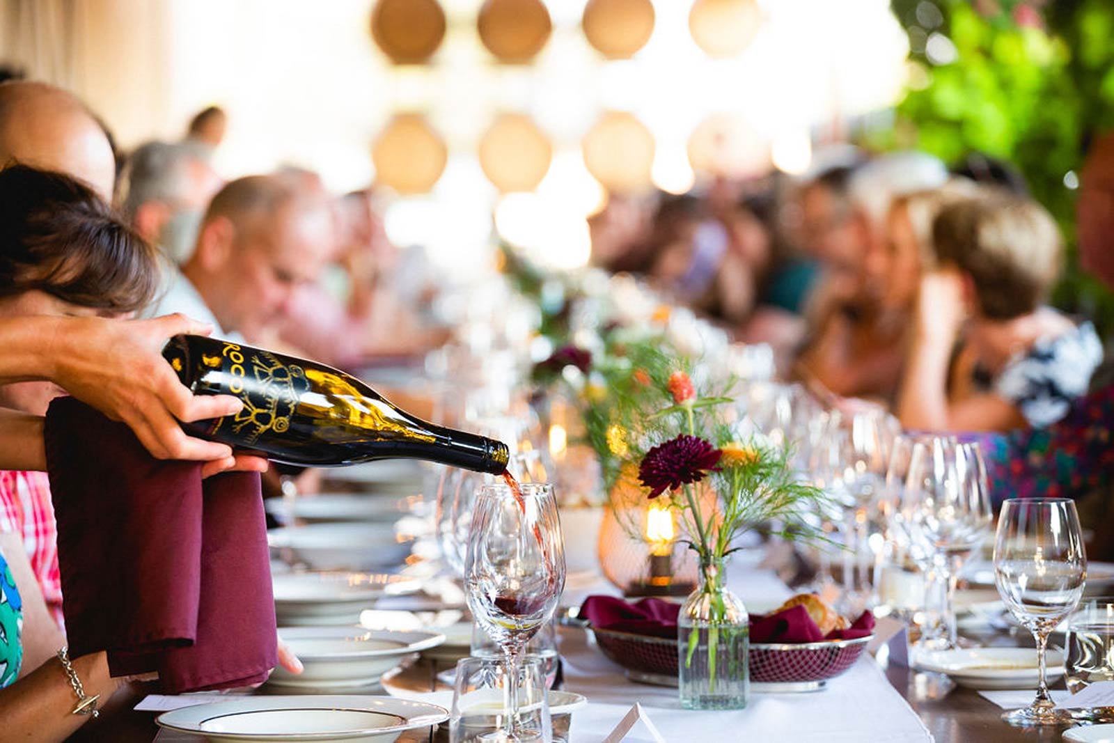 Wine being poured at a table.